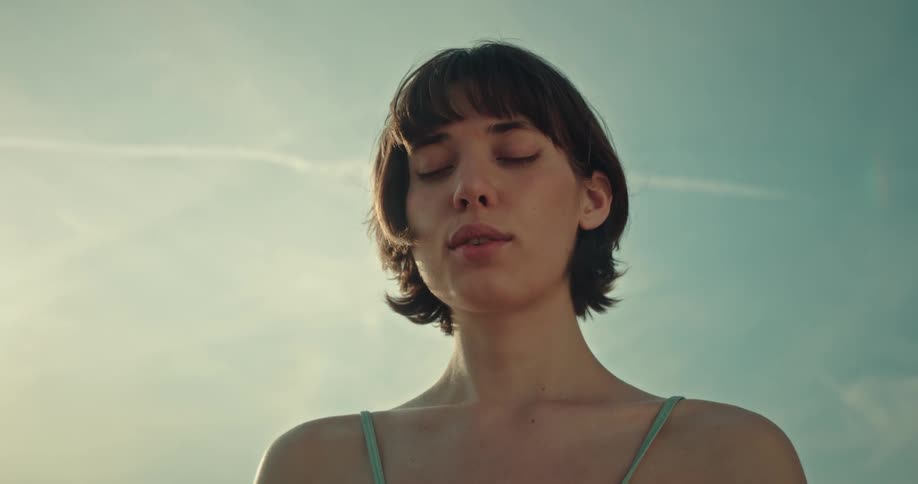 Young lady meditating outdoor by the beach side during the day