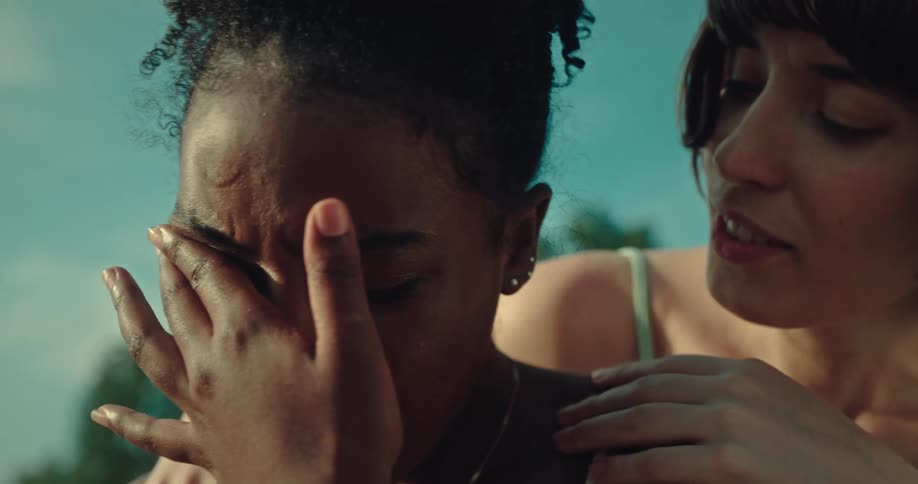 Portrait of a woman crying with her friend comforting her