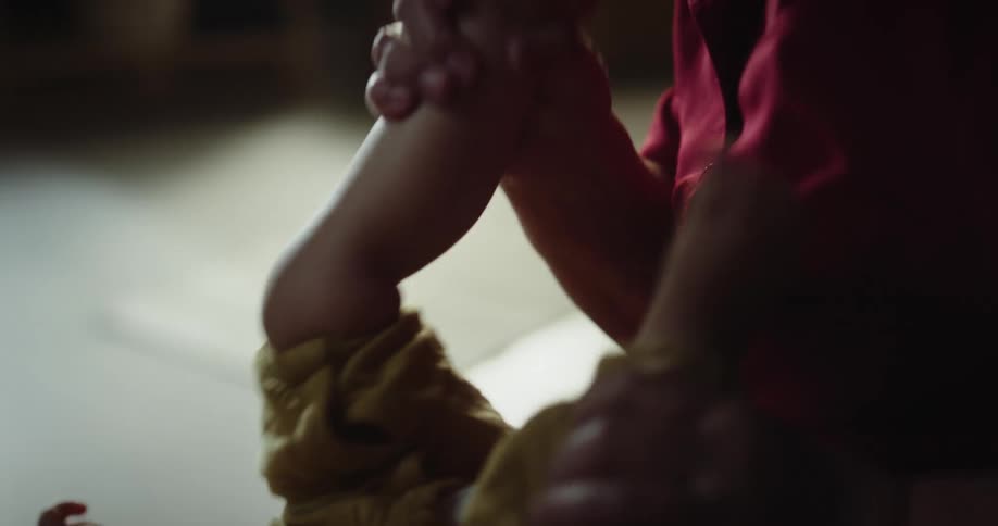 A grandmother is playing with a baby