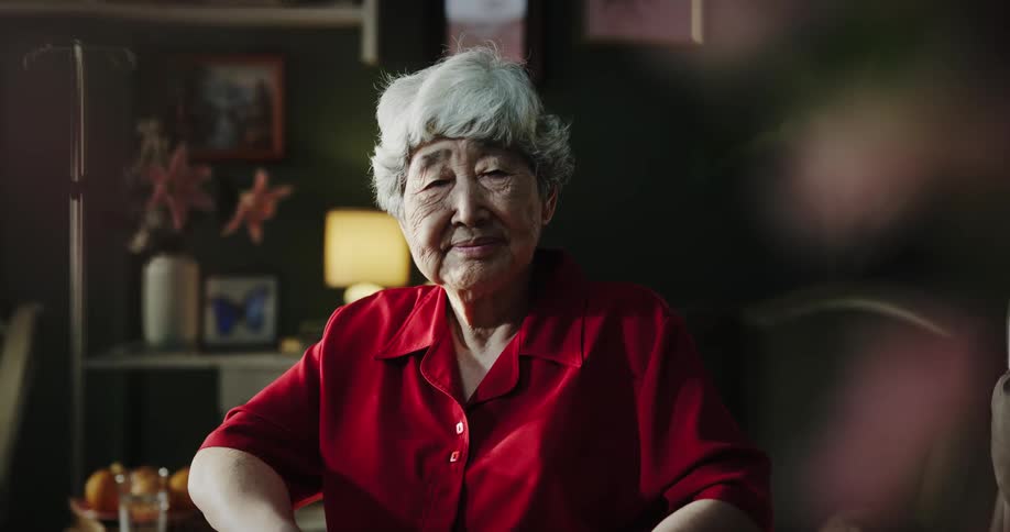 A woman is smiling as she sits