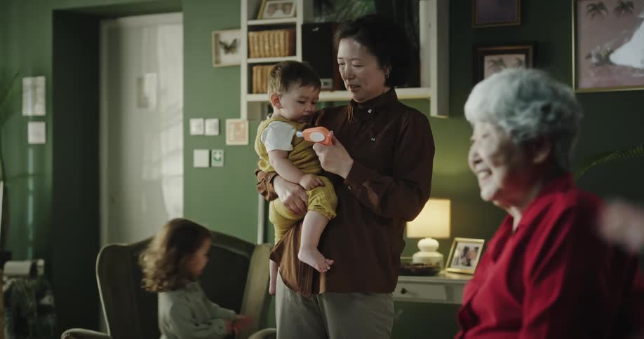 Grandmother and great grandmother watch children at home