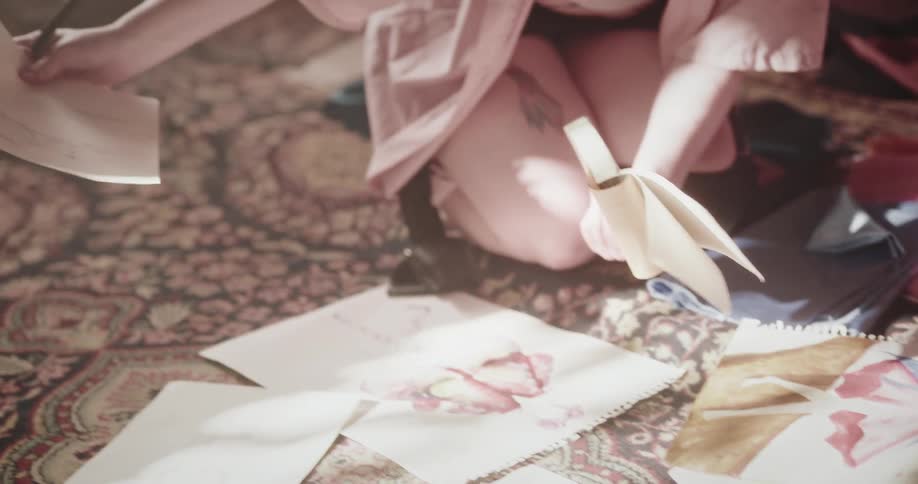 Woman sitting on the floor sketching fashion designs