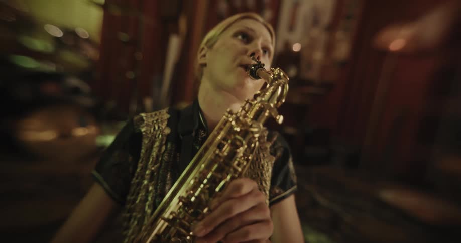 A woman is playing the saxophone