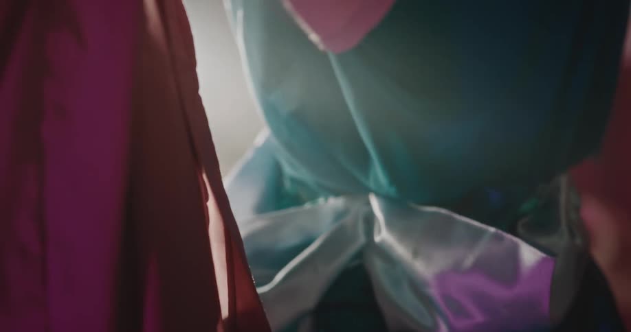 A clip of a lady dressing a mannequin