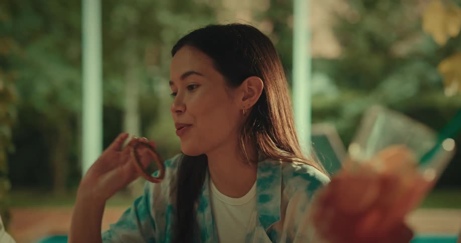 A woman with circles under her eyes talking to friends