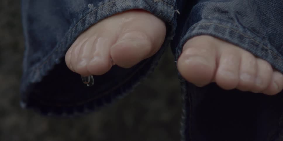 Child's feet drip with water