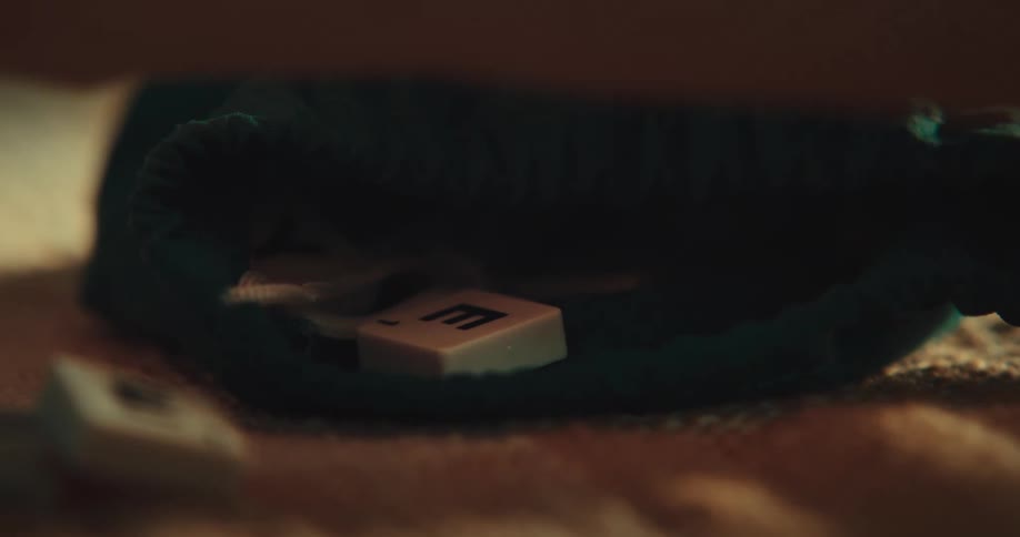 Hand of a person removing letters from a game inside a package