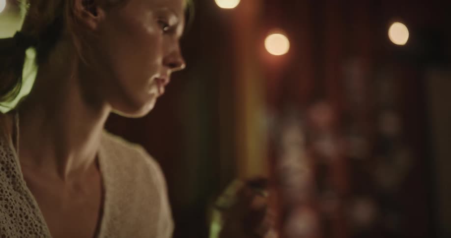 Portrait of a young blonde woman painting a canvas