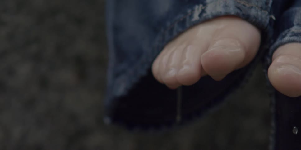 Child's feet are soaked and dripping with water