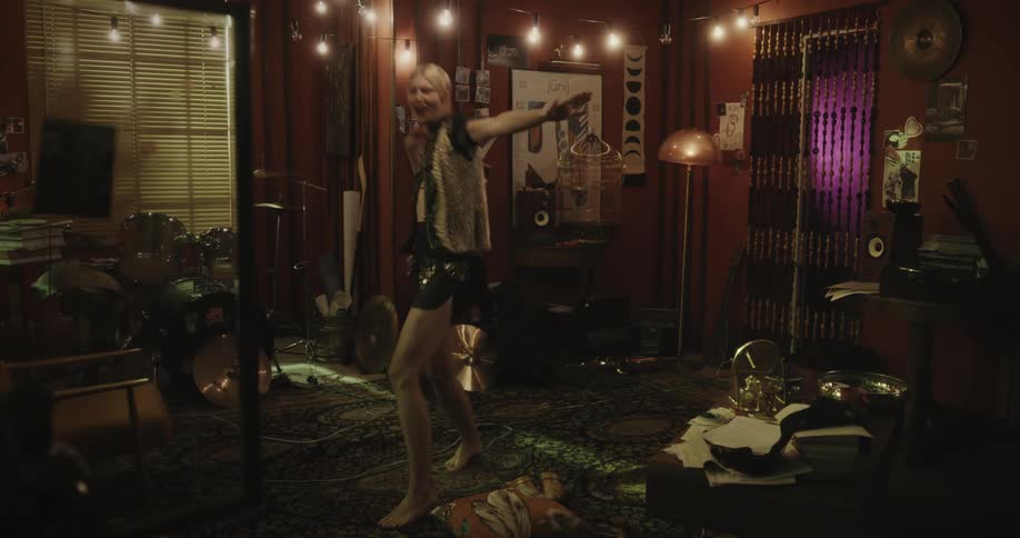 Blonde woman dances indoors