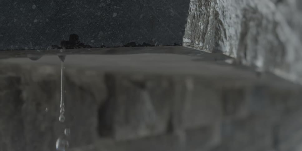 Water drips off of a concrete slab