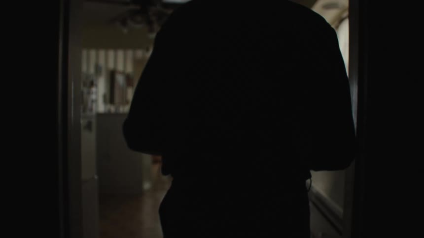 A man enters the kitchen of his house