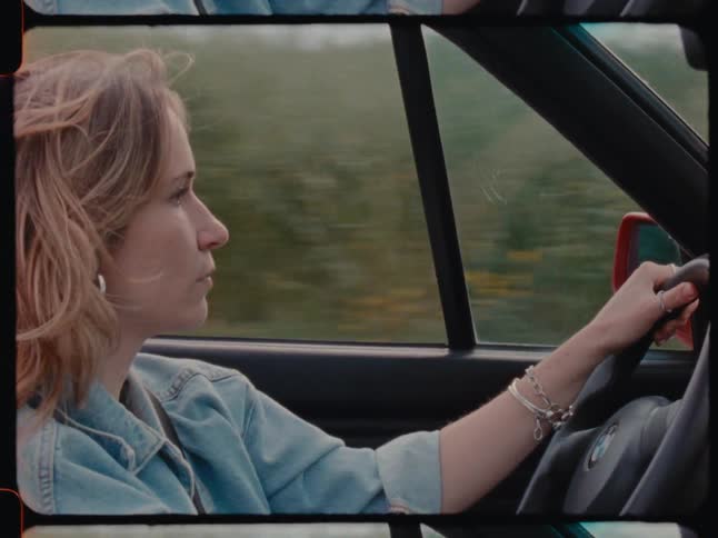 Woman drives a car through the countryside