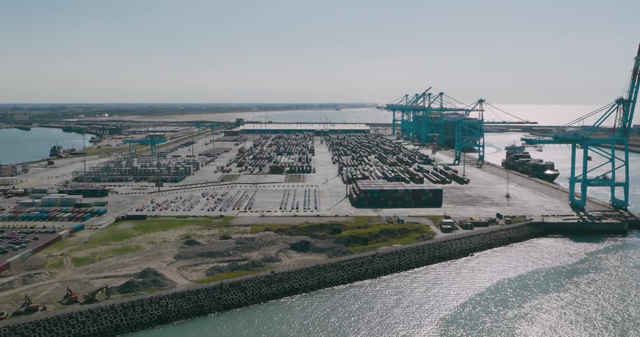 Aerial view of a port logistics center with containers and a ship