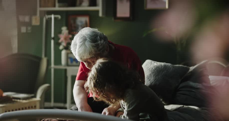 An elderly woman talking to a young child sitting next to her