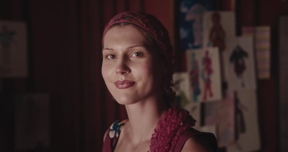 Portrait of a young woman smiling with a scarf in her hair