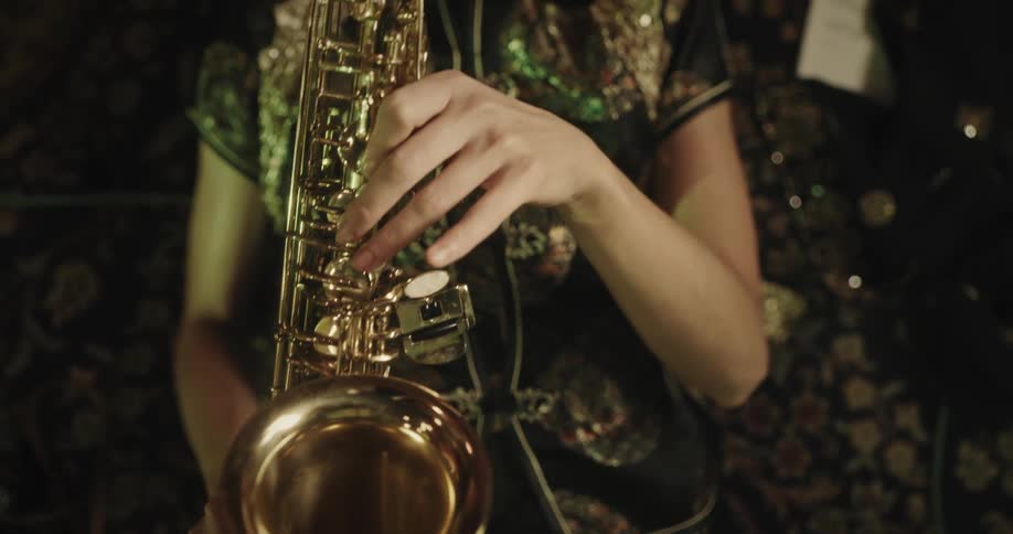 Woman lying on the ground playing a trumpet