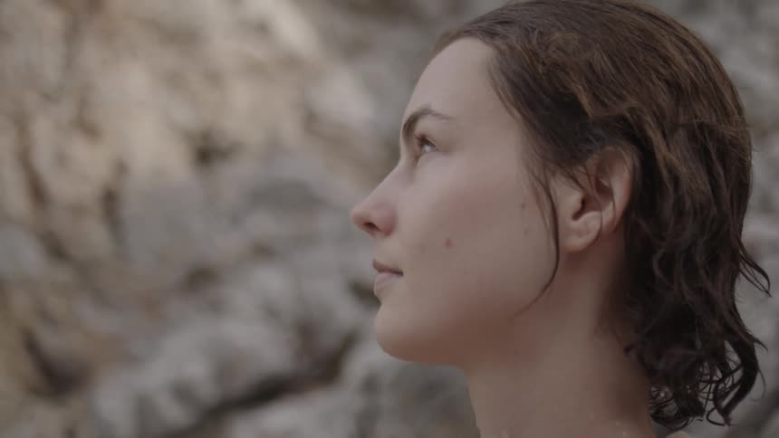 A close up picture of a white lade with water on her neck