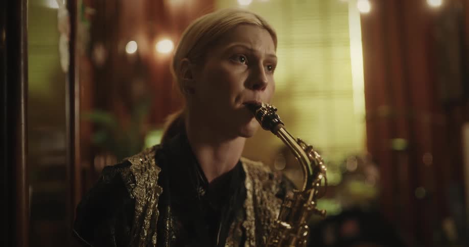 A woman plays a saxophone