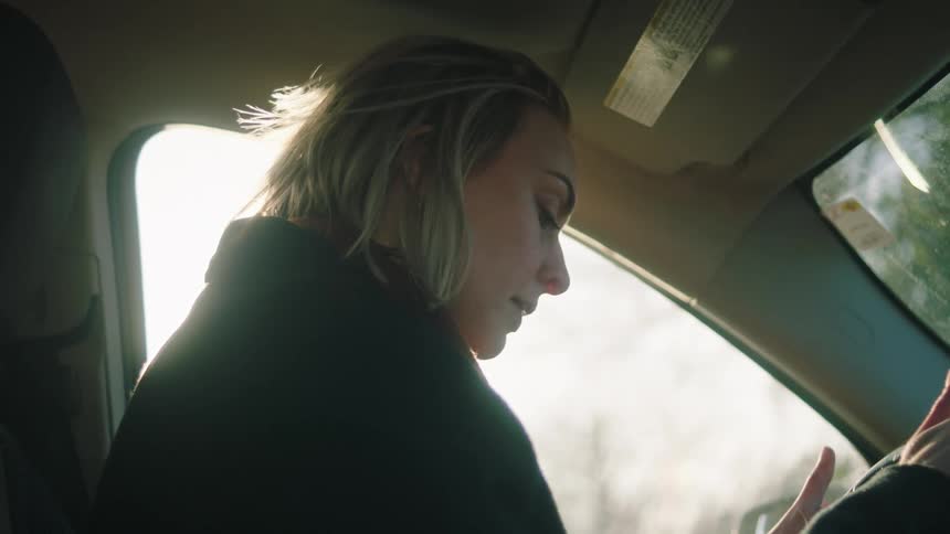 A woman gets into the car and cries
