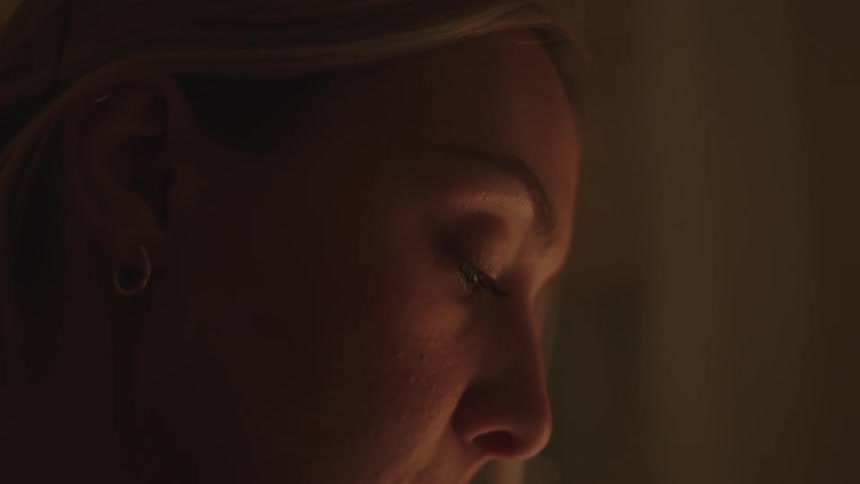 Portrait of a young blonde woman in an indoor setting at night