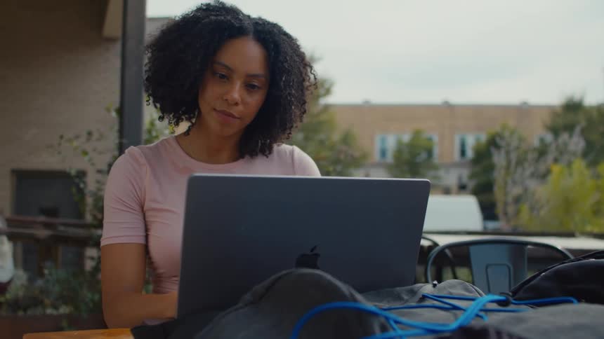 Woman sitting at a table using her laptop