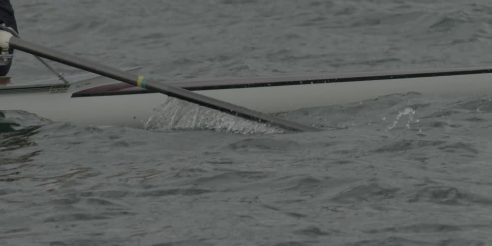 A woman rows her canoe through the water