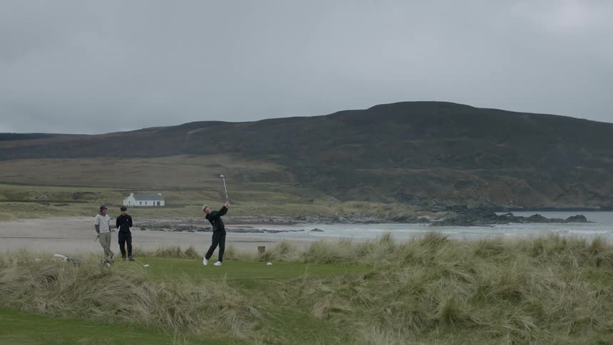Friends playing golf near the beach on a cloudy day