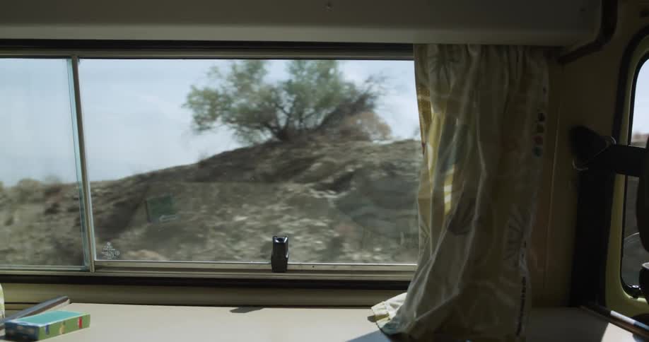 The rv is driving past the mountains