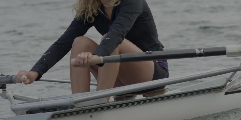 A woman rows her canoe through the water
