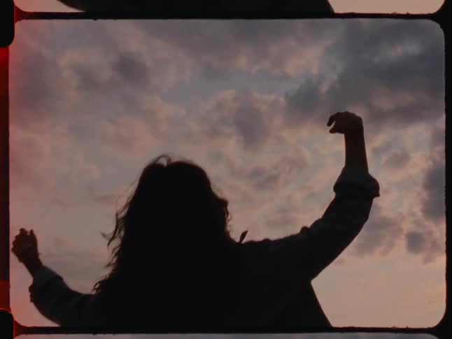 Lady falls on her back at sunset