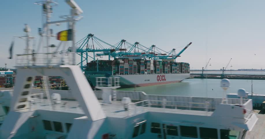 Cranes load a container ship at the harbor