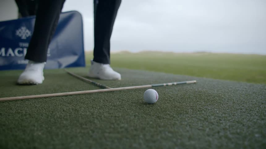 A person takes a golf swing at a golf club