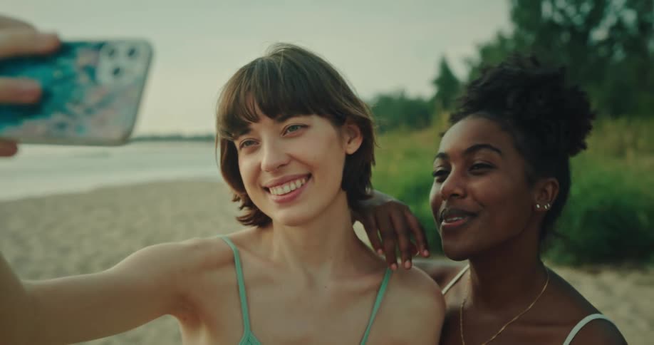 Two female friends taking a selfie at the beach