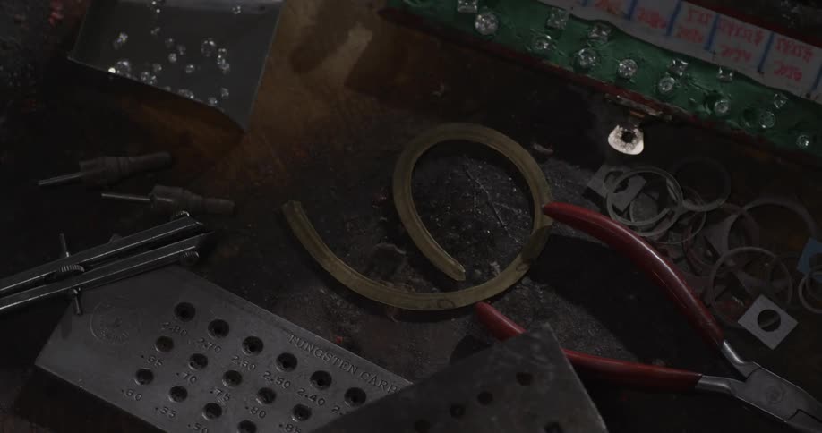 Diamonds and tools are scattered on a tabletop