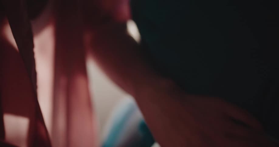 Woman adjusting a bow on another womans dress