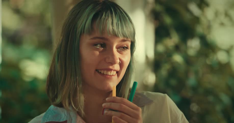 Woman smiles while talking with friends and clinks glasses with them