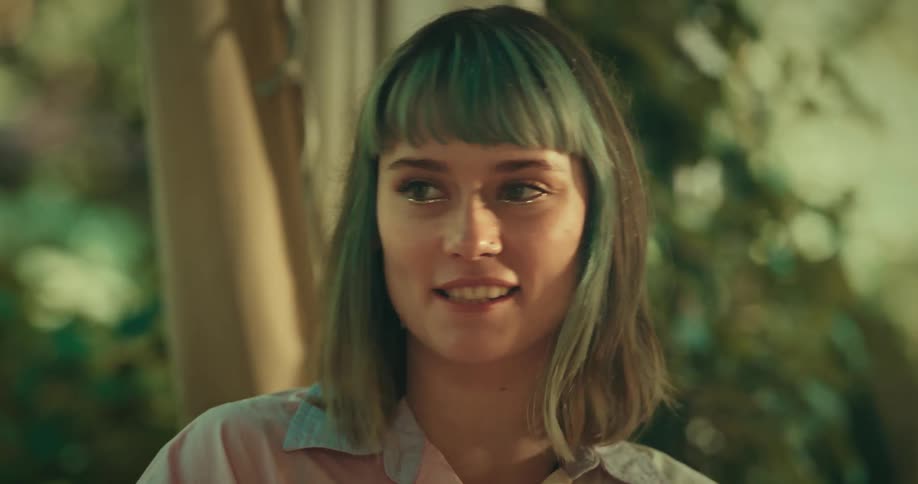 A woman is talking and laughing outside