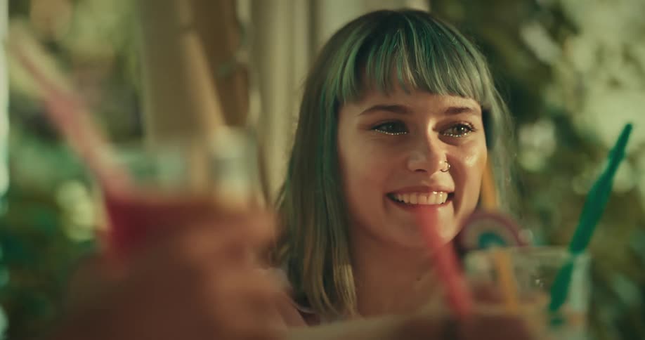Portrait of friends sitting at a table toasting and drinking juice