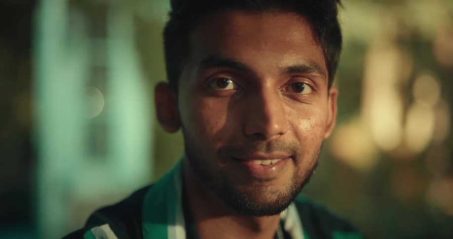 Man smile after taking a sip of drink with a straw