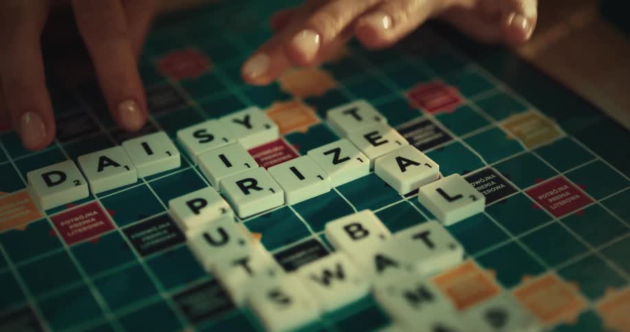 Female hands arranging words on a scrabble board