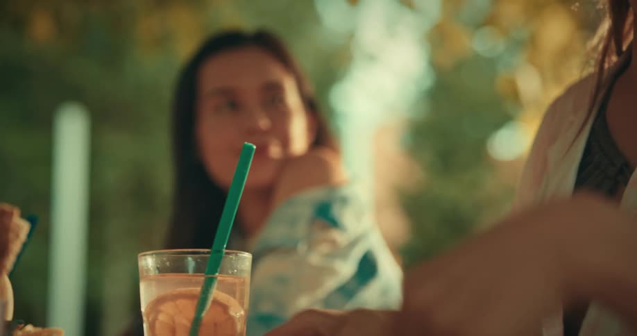 Friends drinking and chatting at an outdoor table
