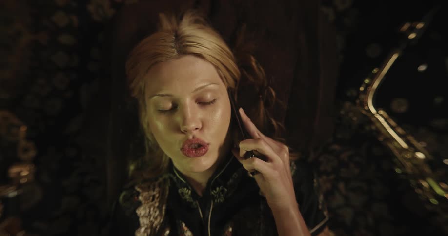 Closeup of a woman talking on the phone with an irritated expression
