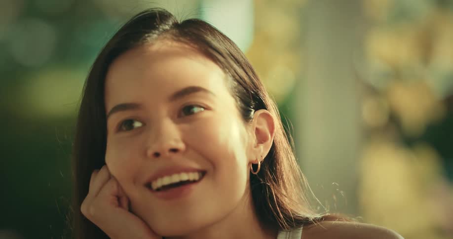 A smiling woman talking outdoors