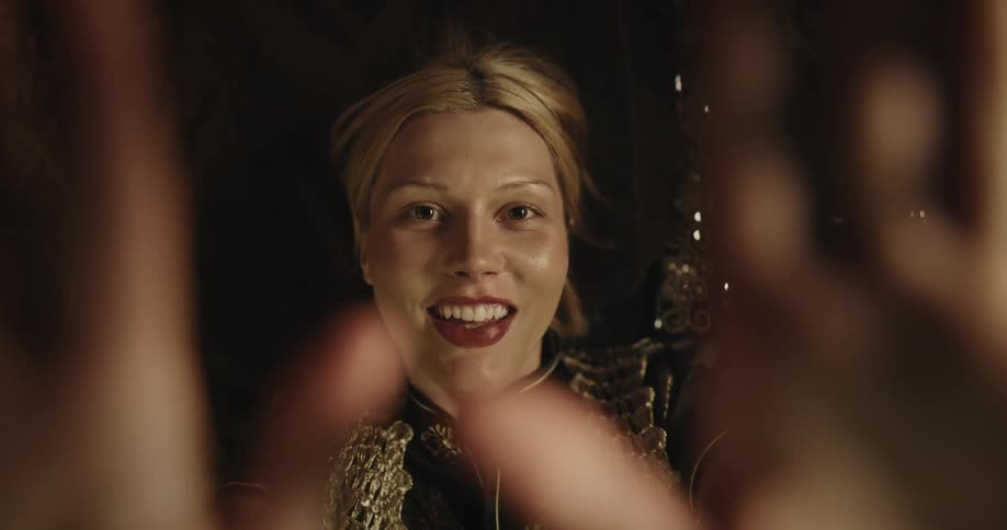 A woman blows a kiss and laughs