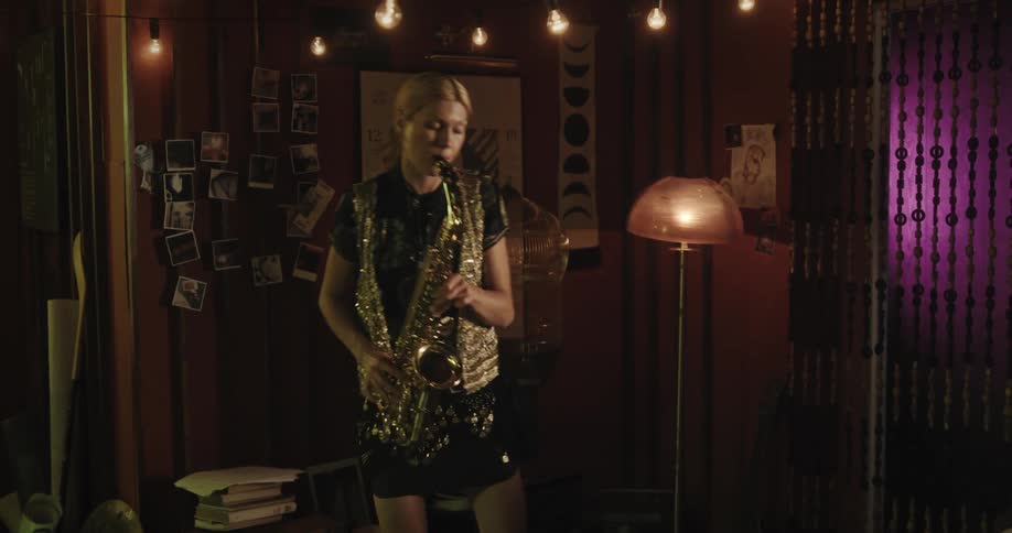 A woman is playing the saxophone