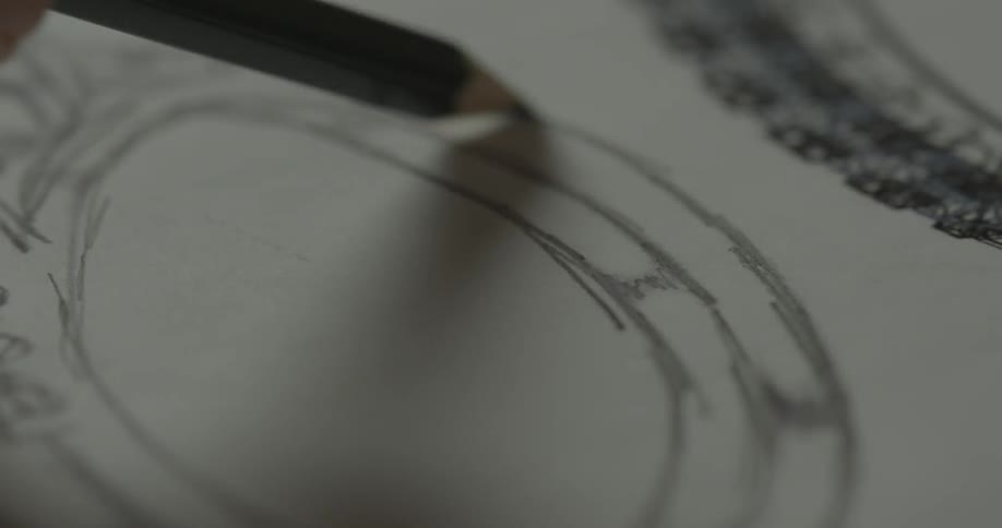 An artist sketches on paper