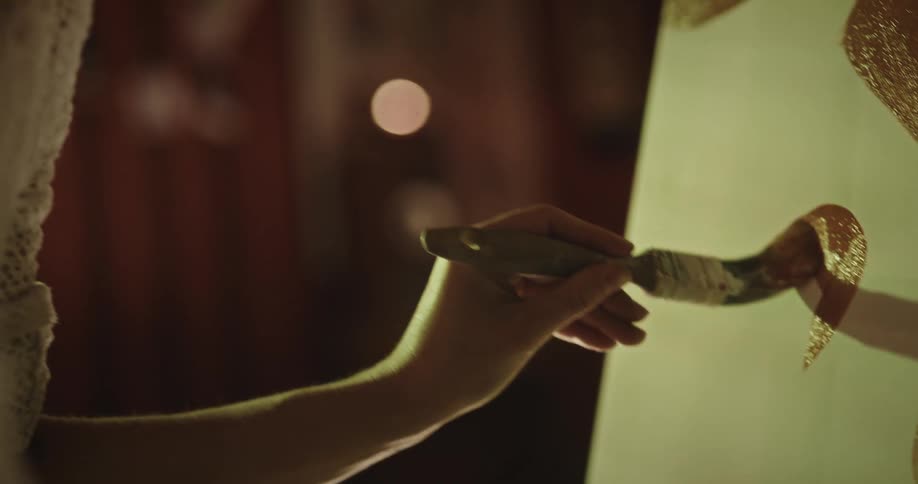 A clip of a woman painting calligraphy