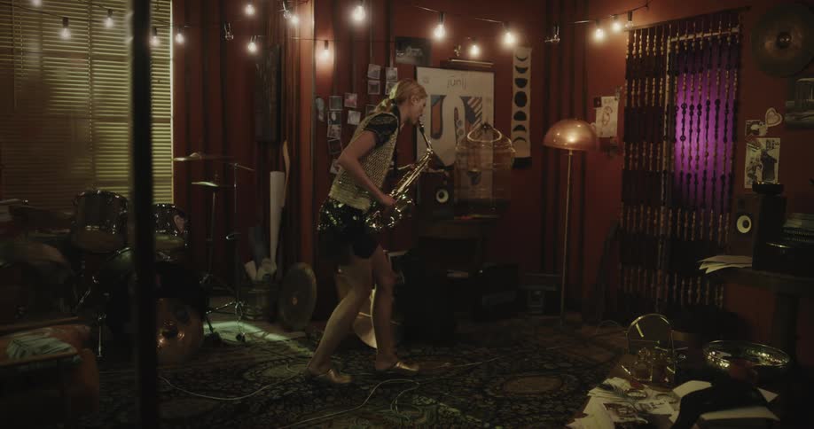 Woman indoors rehearsing with a trumpet