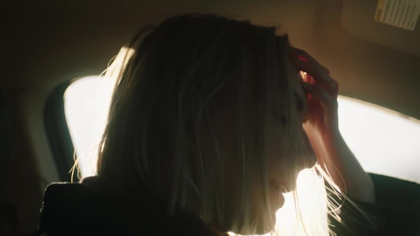 A woman is sad in her car